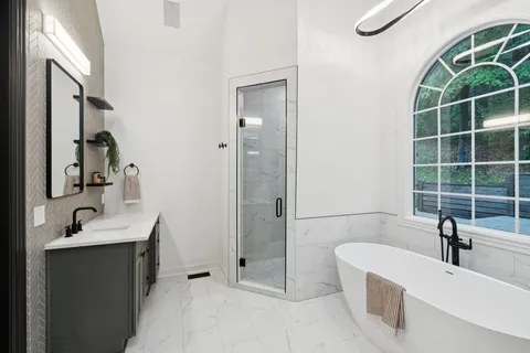 an empty room with a window and a ceiling fan