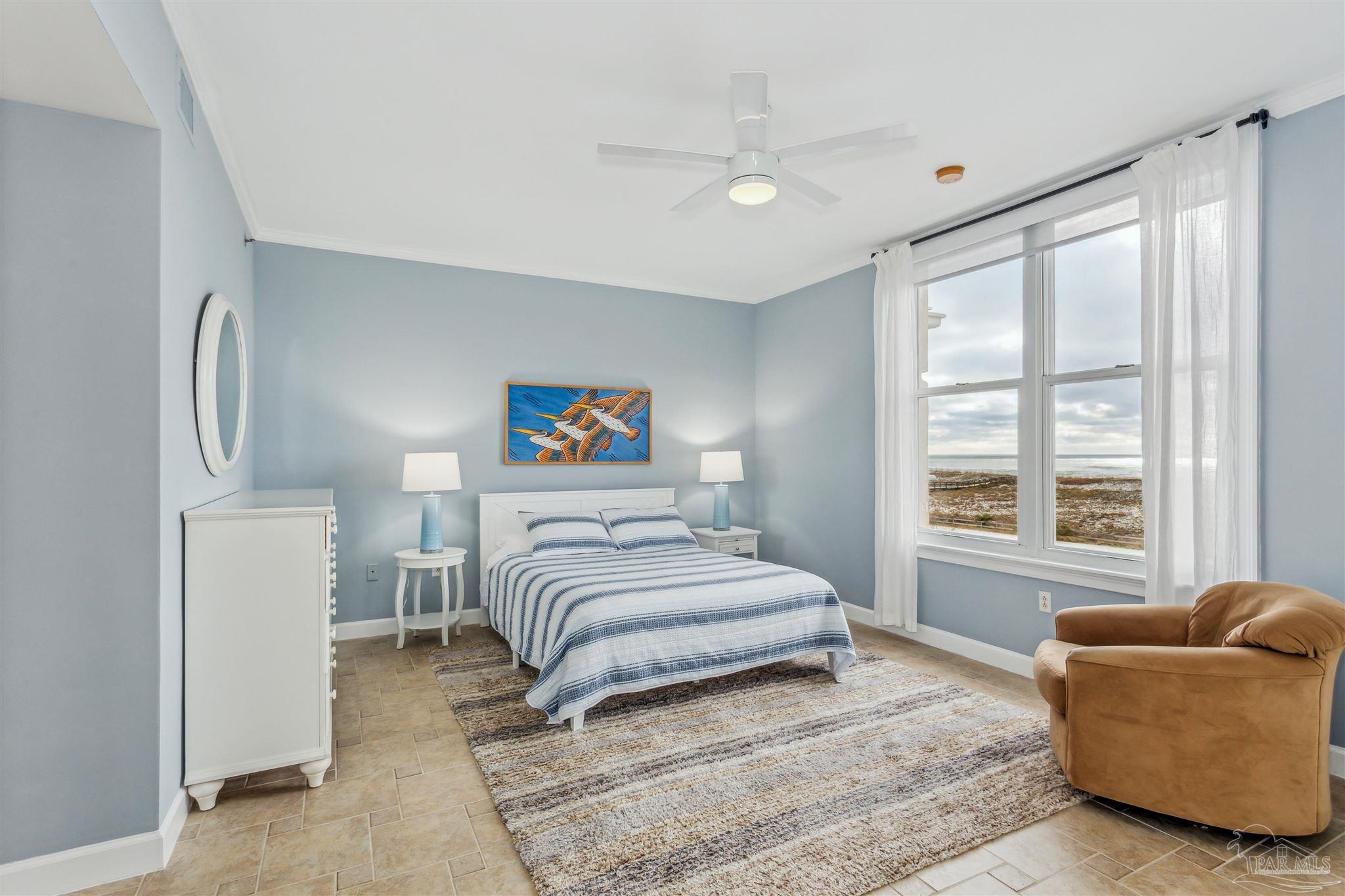 800 Fort Pickens Road, Unit 204 Pensacola Beach, FL 32561 - Photo 22 of 45 a bedroom with a bed and a couch with window