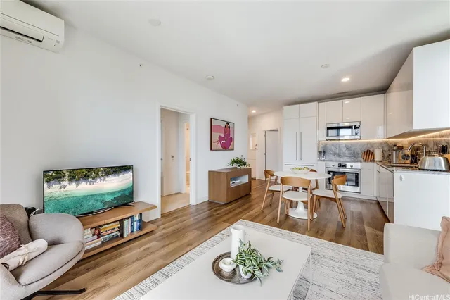 a kitchen with stainless steel appliances a dining table chairs and refrigerator