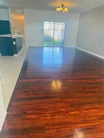 a view of a room with wooden floor