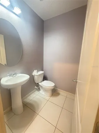 a white toilet sitting next to a bathroom sink