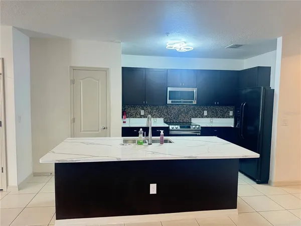 a kitchen with a sink cabinets and appliances