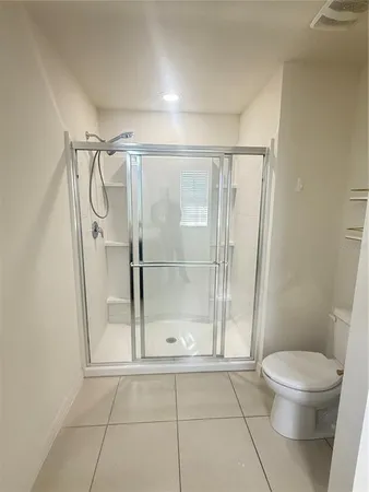 a bathroom with a glass door shower