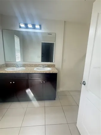 a bathroom with a granite countertop sink and mirror