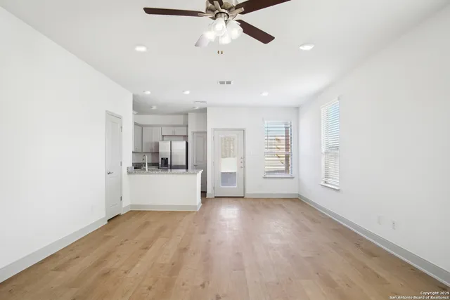 a view of a kitchen with a sink and a refrigerator