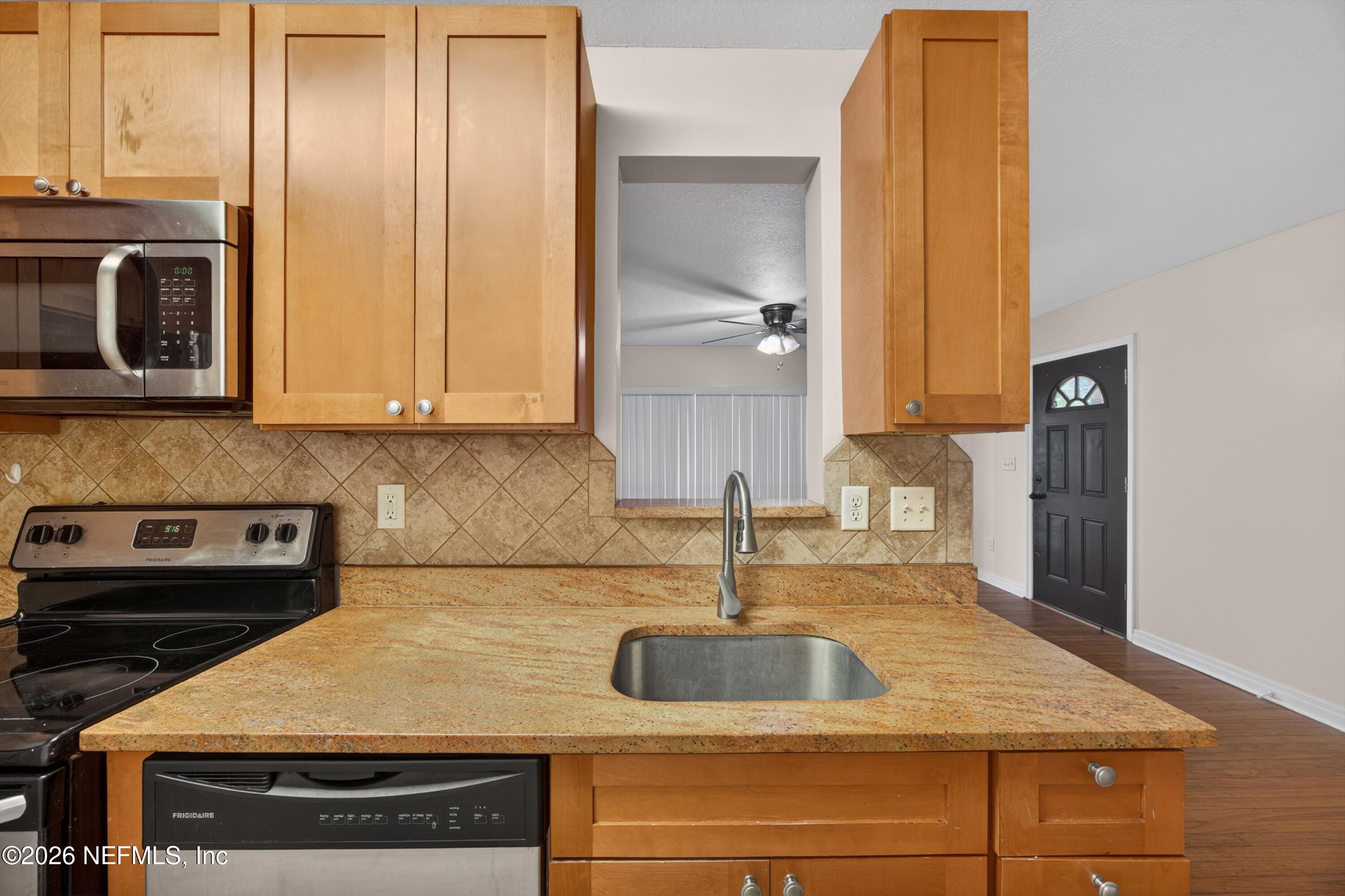 4231 Rendale Drive North Jacksonville, FL 32210 - Photo 12 of 37 a kitchen with kitchen island granite countertop a sink and cabinets