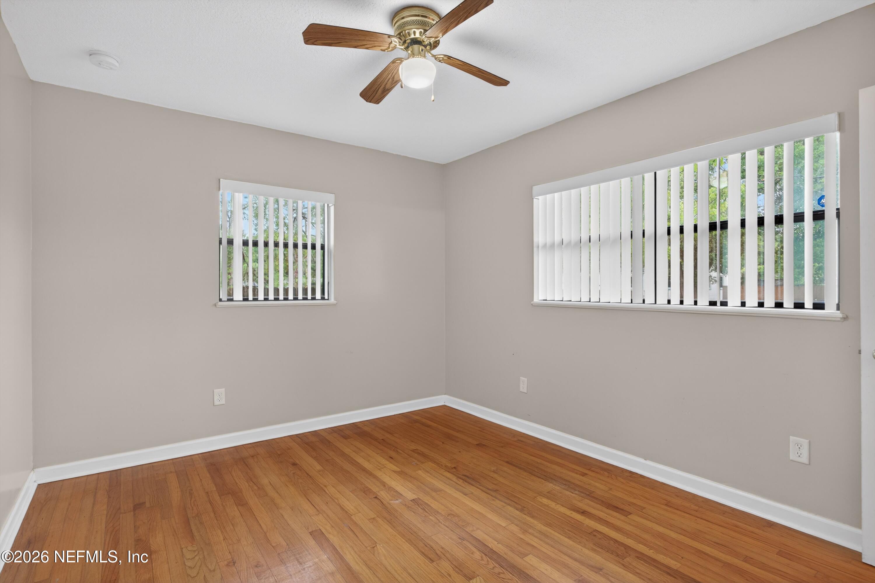 4231 Rendale Drive North Jacksonville, FL 32210 - Photo 15 of 37 a view of an empty room with wooden floor and a window