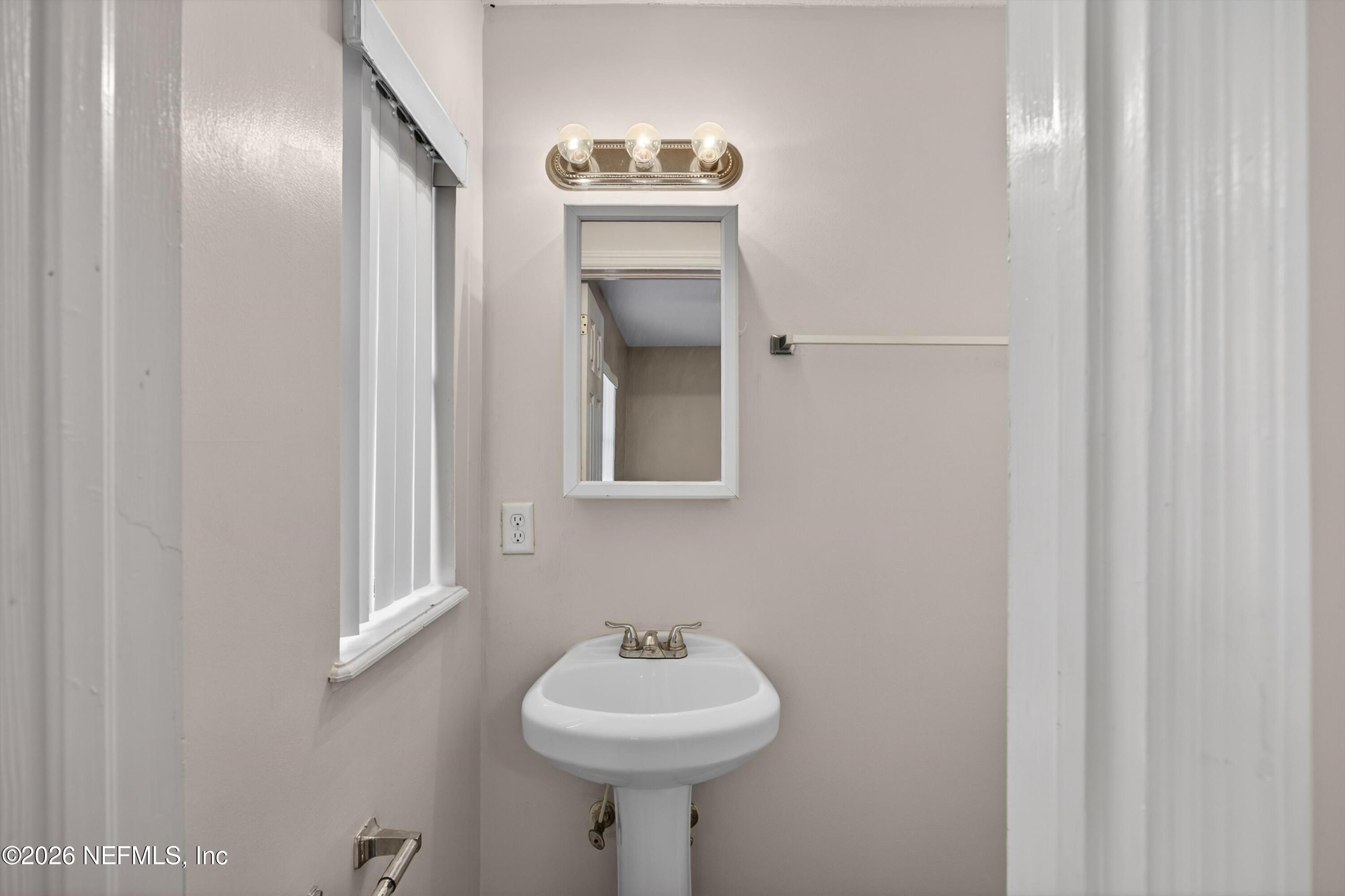 4231 Rendale Drive North Jacksonville, FL 32210 - Photo 18 of 37 a bathroom with a sink and a mirror