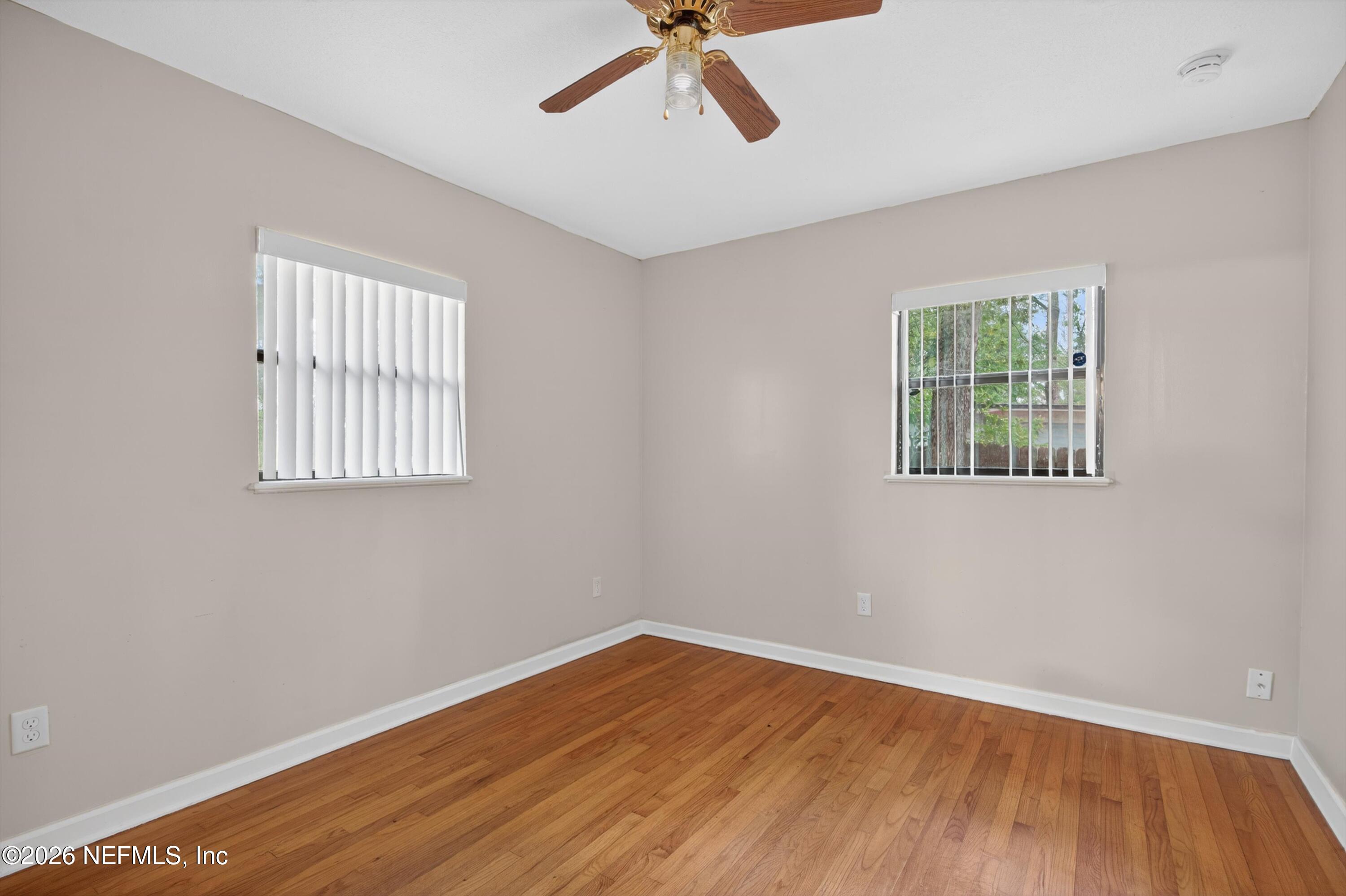 4231 Rendale Drive North Jacksonville, FL 32210 - Photo 20 of 37 a view of empty room with wooden floor and fan