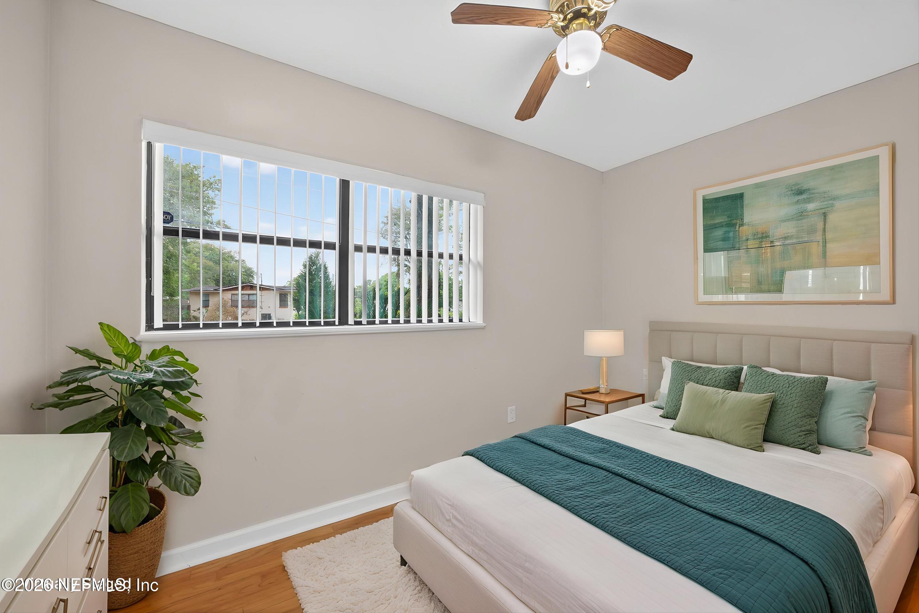 4231 Rendale Drive North Jacksonville, FL 32210 - Photo 25 of 37 a bedroom with a bed and a potted plant
