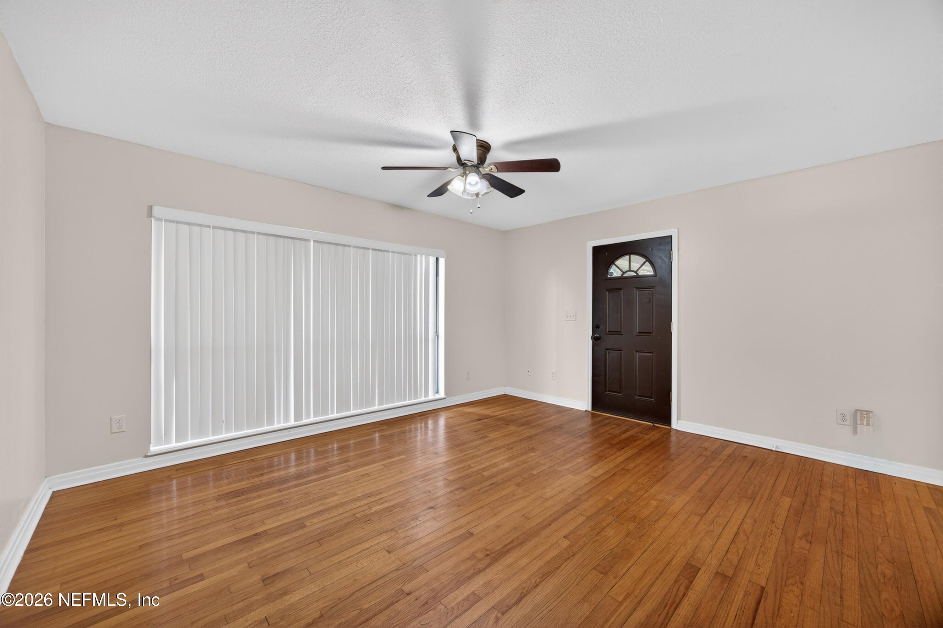 4231 Rendale Drive North Jacksonville, FL 32210 - Photo 3 of 37 wooden floor in an empty room with a window