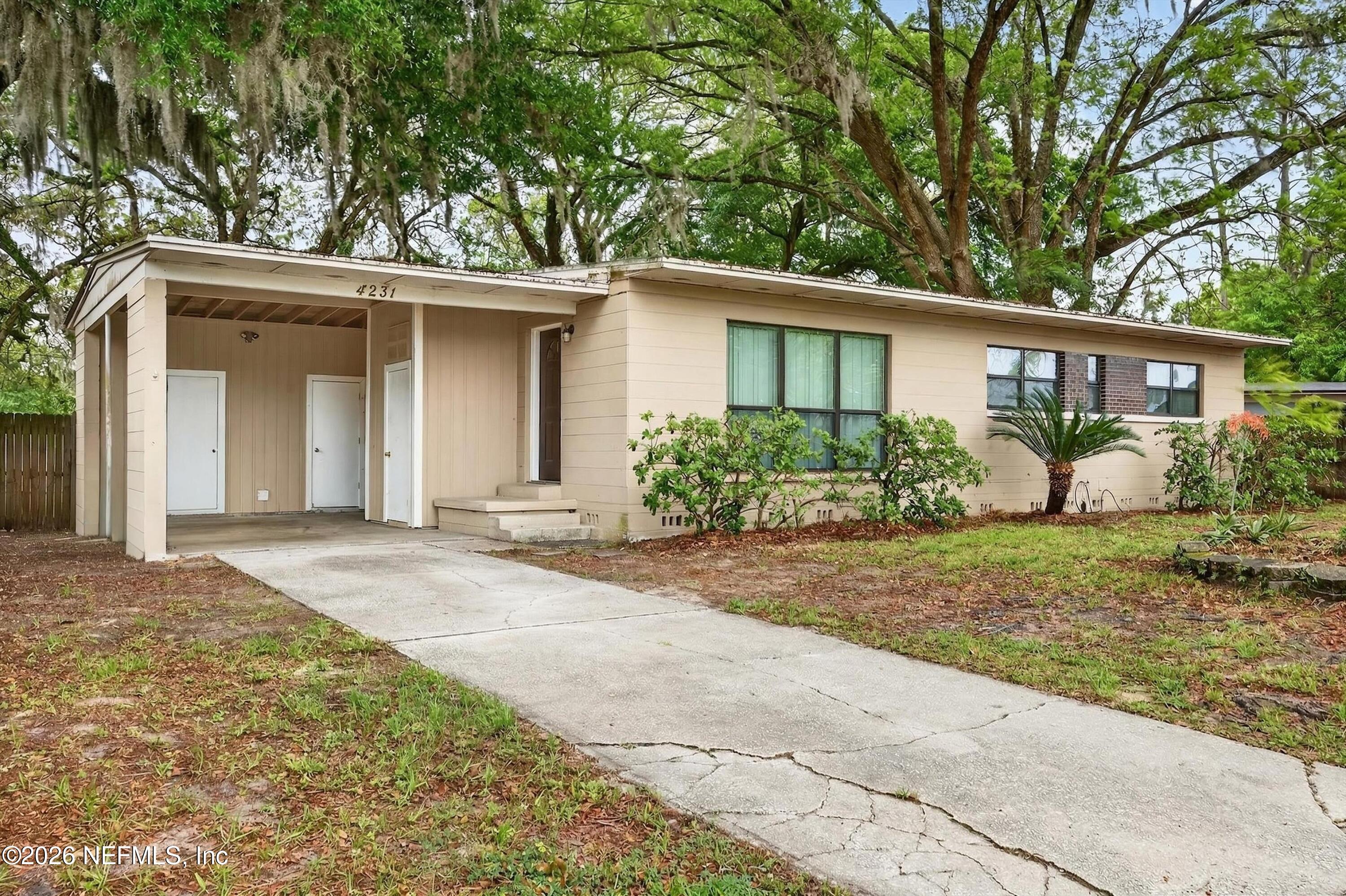 4231 Rendale Drive North Jacksonville, FL 32210 - Photo 34 of 37 front view of a house with potted plants and large trees