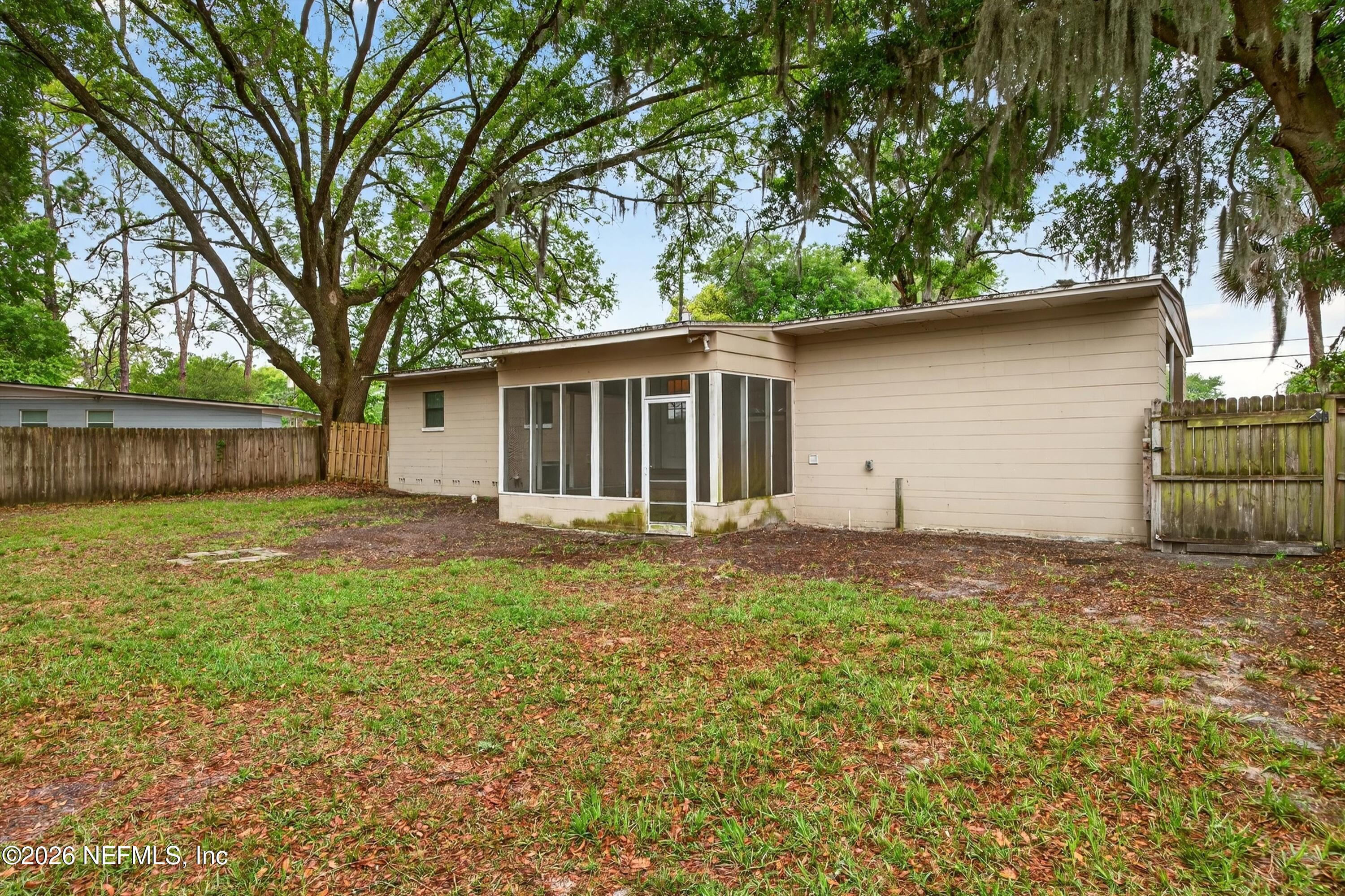4231 Rendale Drive North Jacksonville, FL 32210 - Photo 37 of 37 a backyard of a house with large trees and a barn