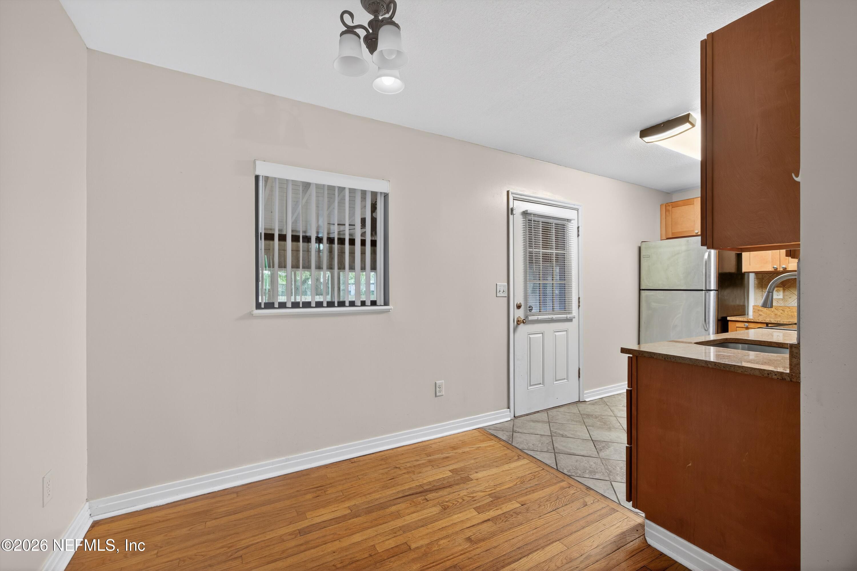 4231 Rendale Drive North Jacksonville, FL 32210 - Photo 5 of 37 a view of kitchen and empty room with wooden floor