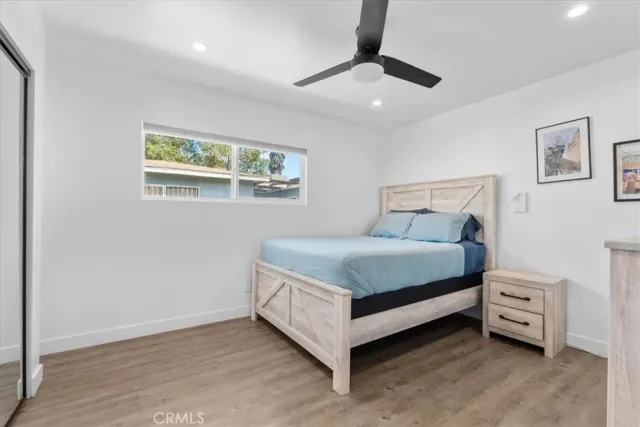 a bed sitting in a bedroom next to a window