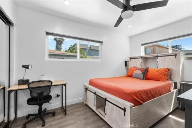 a bedroom with a bed and a desk