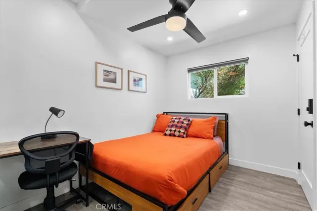 a bedroom with a bed and a desk