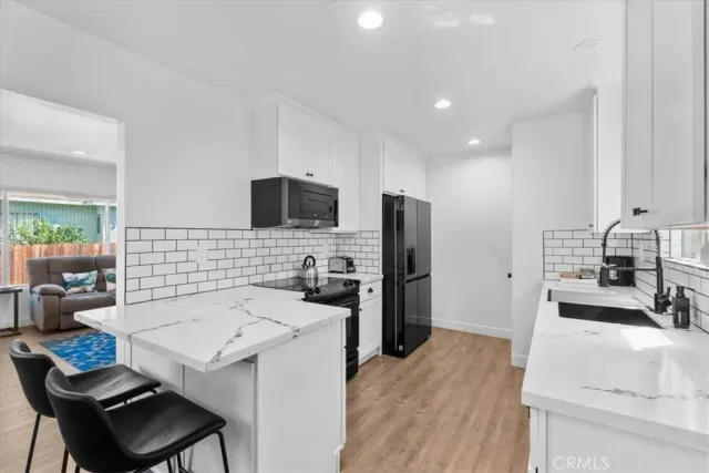 a kitchen with a sink and a stove top oven