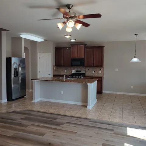a view of kitchen with cabinets and stainless steel appliances