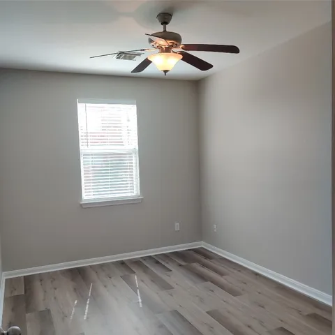 wooden floor in a hall with an empty room