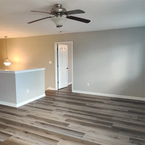 a view of a kitchen with a sink and wooden floor