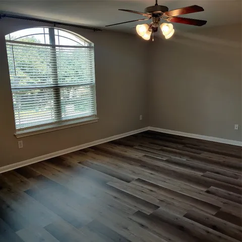 a spacious bathroom with a tub sink and mirror