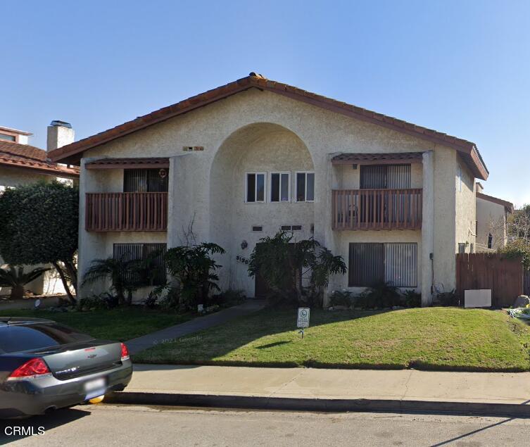 5130 West Wooley Road, Unit 2 Oxnard, CA 93035 - Photo 2 of 11 a front view of a house with a yard and garage