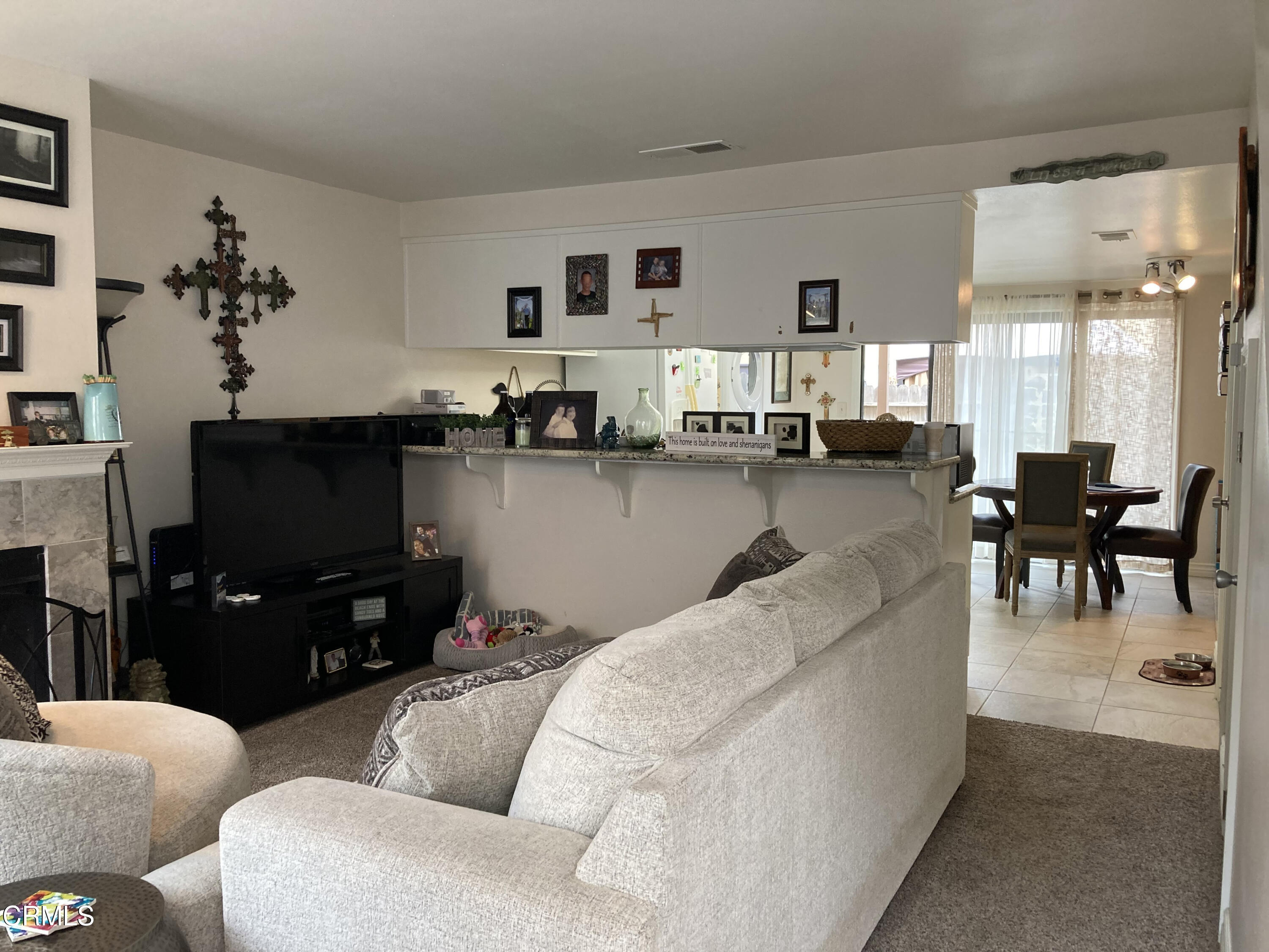 5130 West Wooley Road, Unit 2 Oxnard, CA 93035 - Photo 3 of 11 a living room with furniture and a flat screen tv