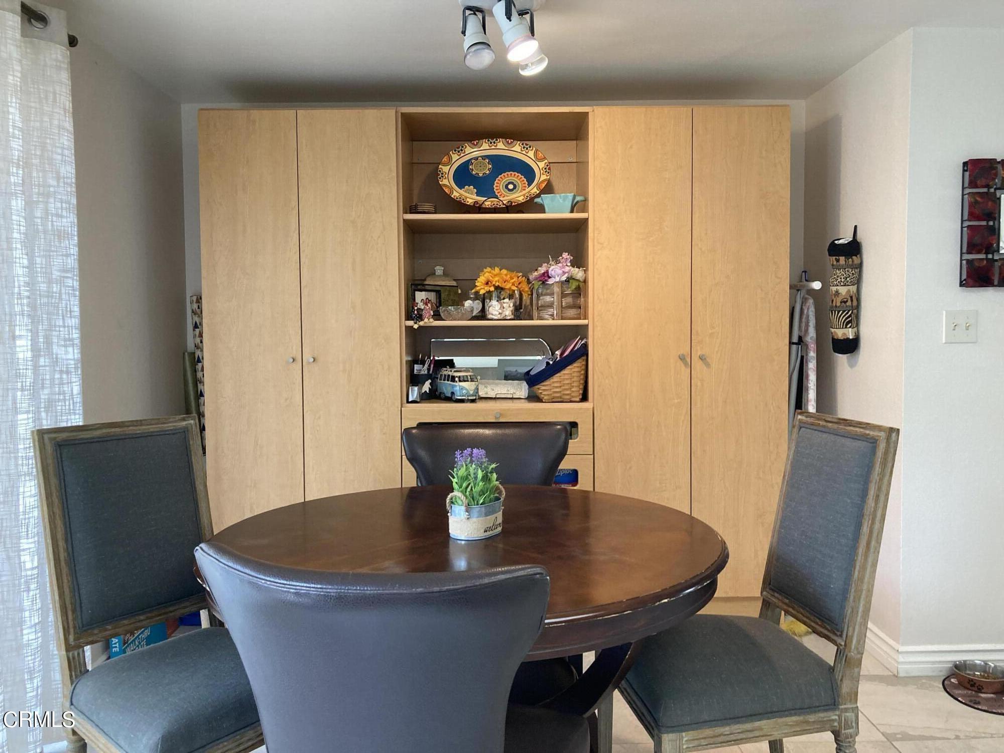 5130 West Wooley Road, Unit 2 Oxnard, CA 93035 - Photo 6 of 11 a view of a dining room with furniture and wooden floor