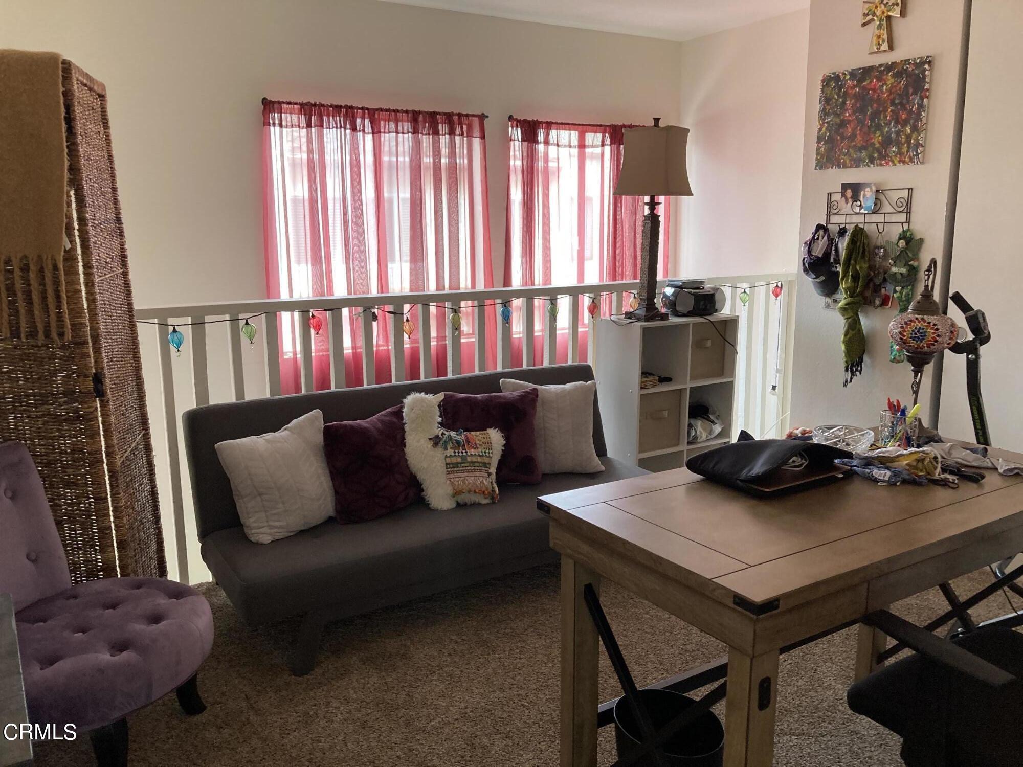 5130 West Wooley Road, Unit 2 Oxnard, CA 93035 - Photo 10 of 11 a living room with furniture and a window