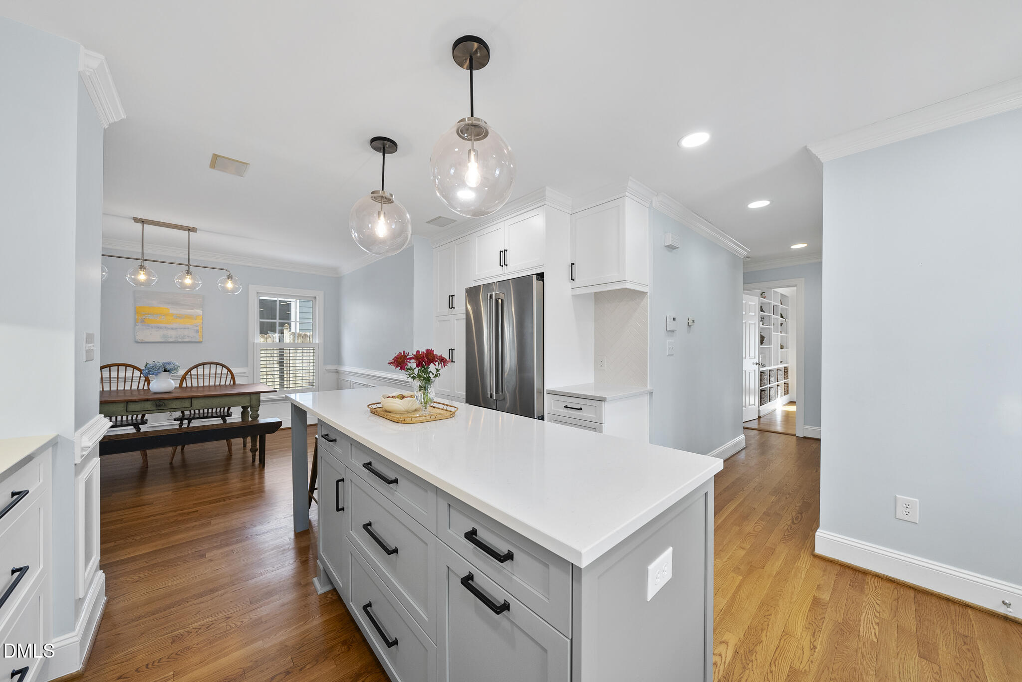 325 Morrison Avenue Raleigh, NC 27608 - Photo 10 of 42 a kitchen with kitchen island a stove a sink a refrigerator and chairs
