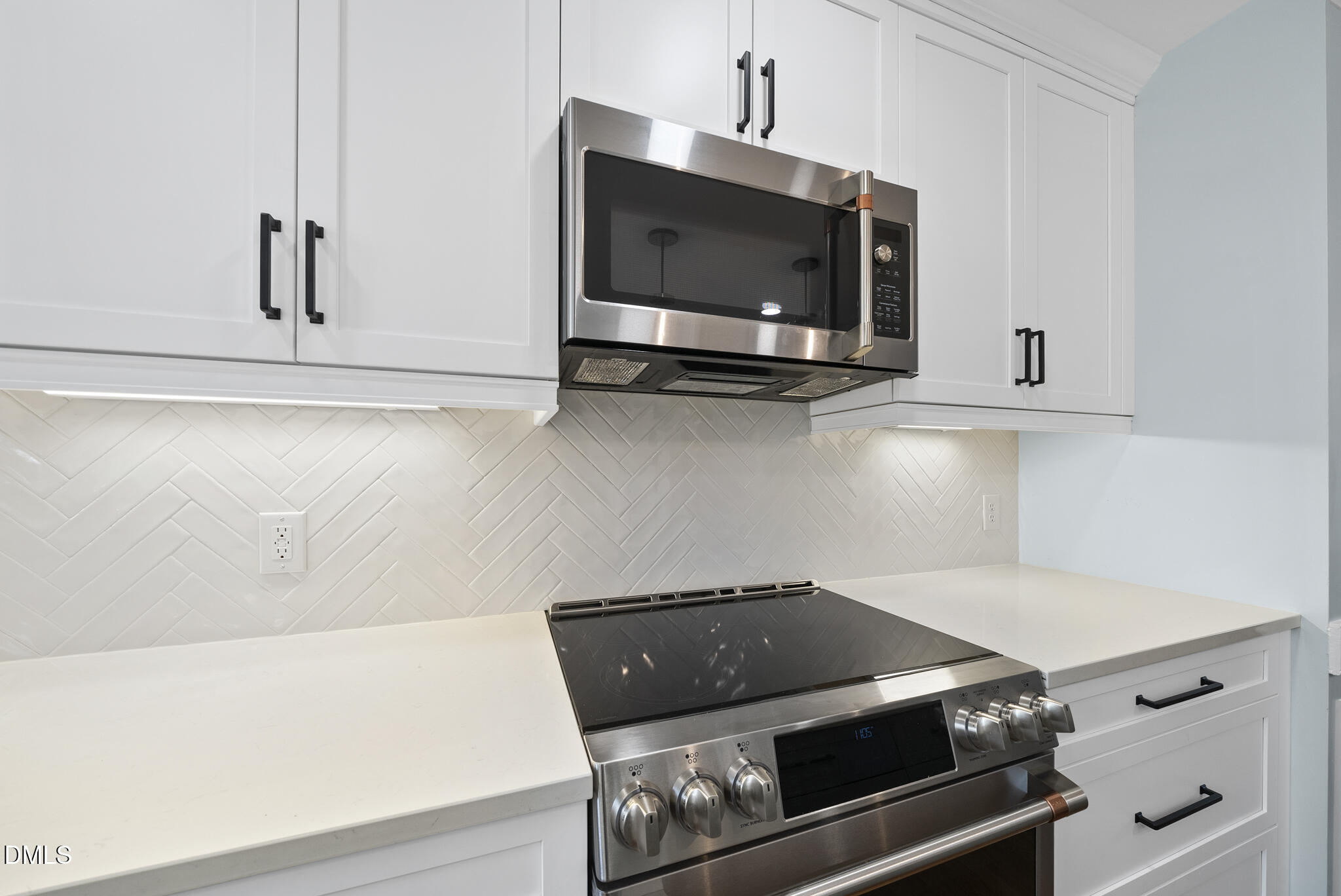 325 Morrison Avenue Raleigh, NC 27608 - Photo 12 of 42 a living room with a stove and a flat screen tv