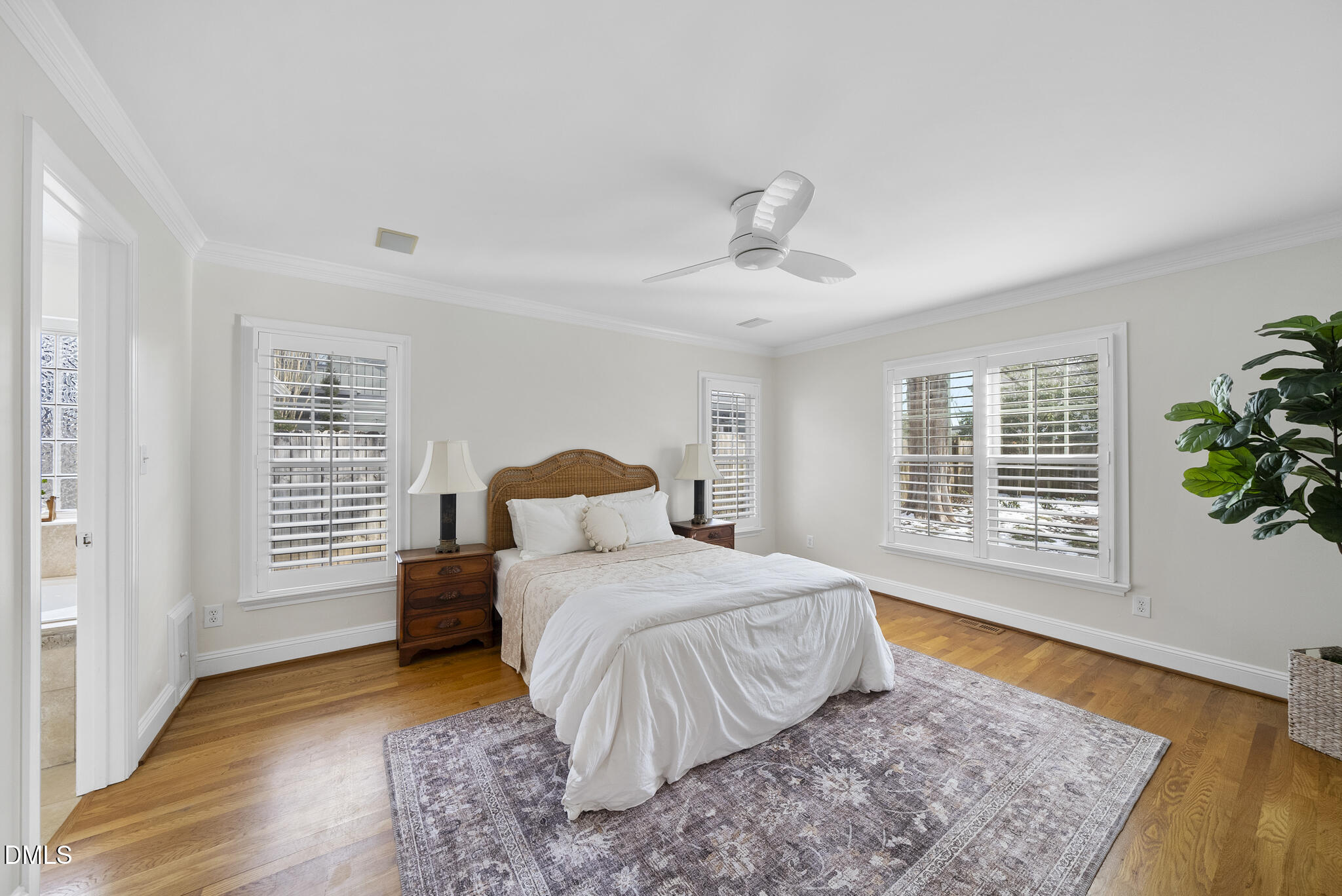 325 Morrison Avenue Raleigh, NC 27608 - Photo 15 of 42 a bedroom with a large bed and a potted plant