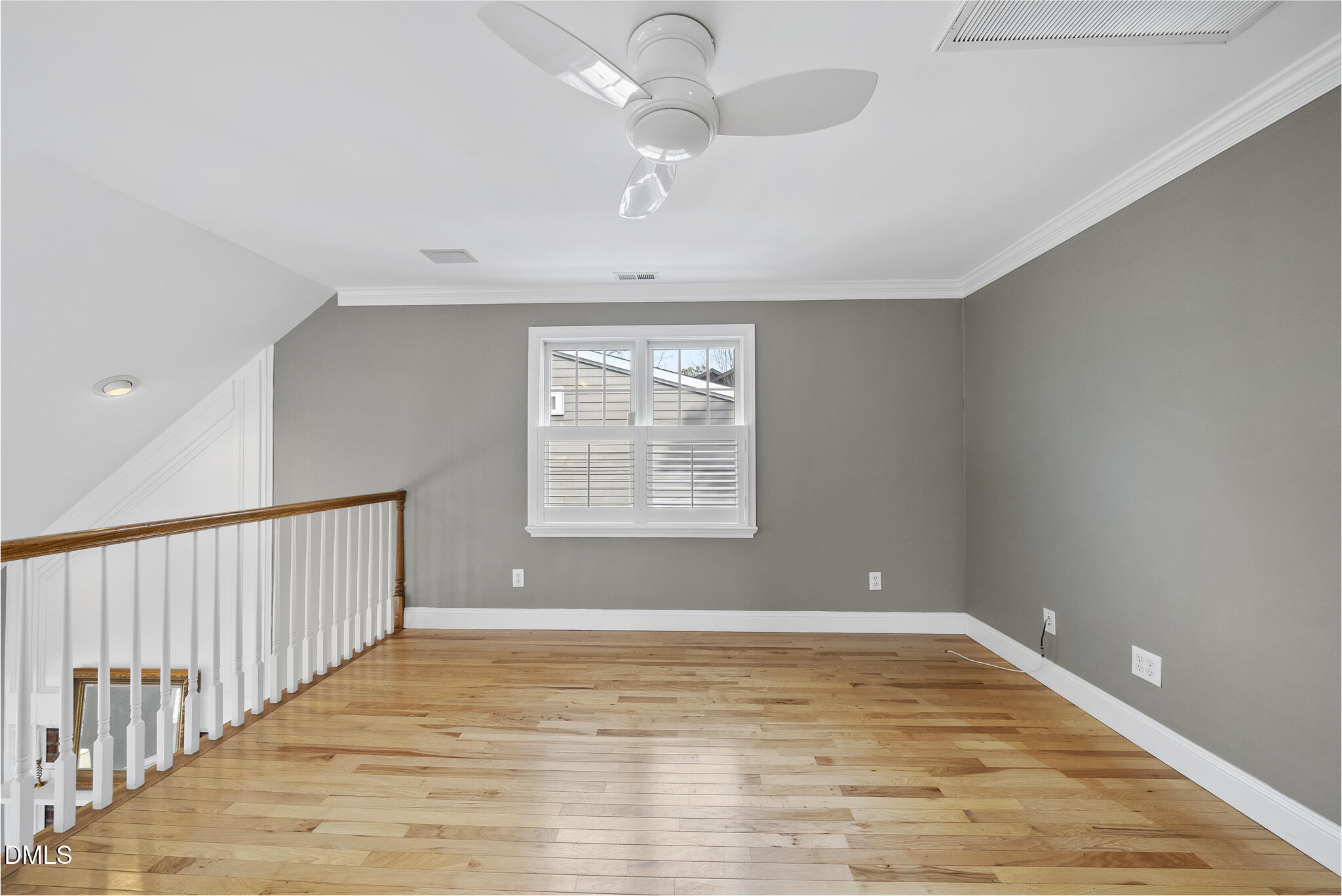 325 Morrison Avenue Raleigh, NC 27608 - Photo 26 of 42 a view of an empty room with wooden floor and a window