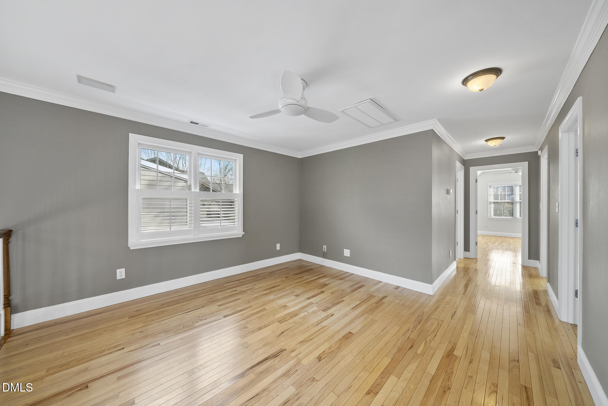 325 Morrison Avenue Raleigh, NC 27608 - Photo 27 of 42 a view of an empty room with wooden floor and a window