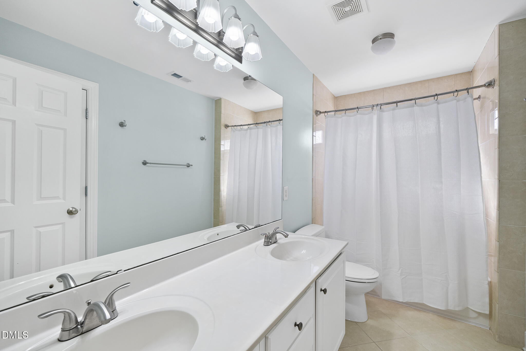 325 Morrison Avenue Raleigh, NC 27608 - Photo 29 of 42 a bathroom with double vanity sink and a mirror