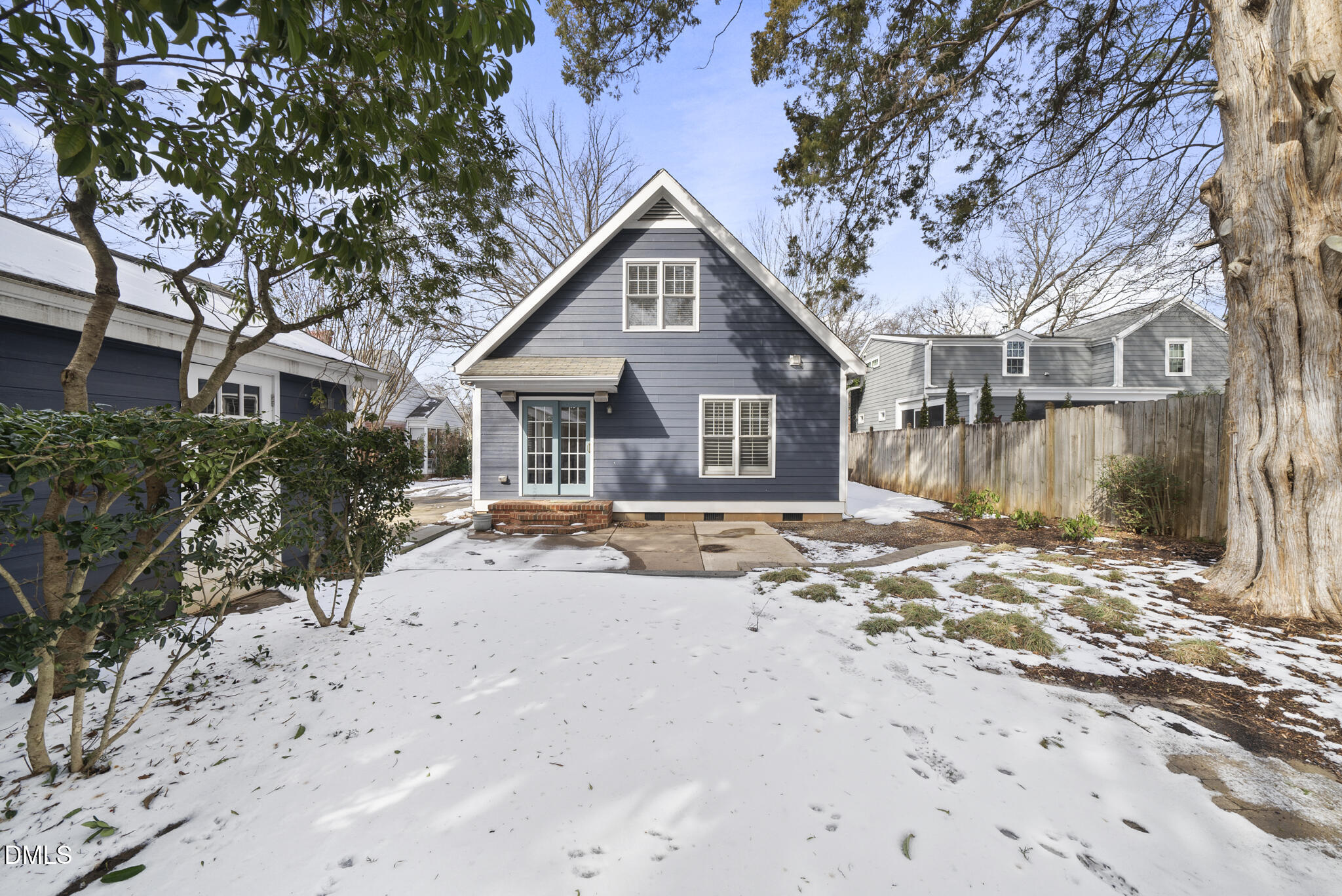 325 Morrison Avenue Raleigh, NC 27608 - Photo 35 of 42 a view of a house with a yard covered with snow in front of house