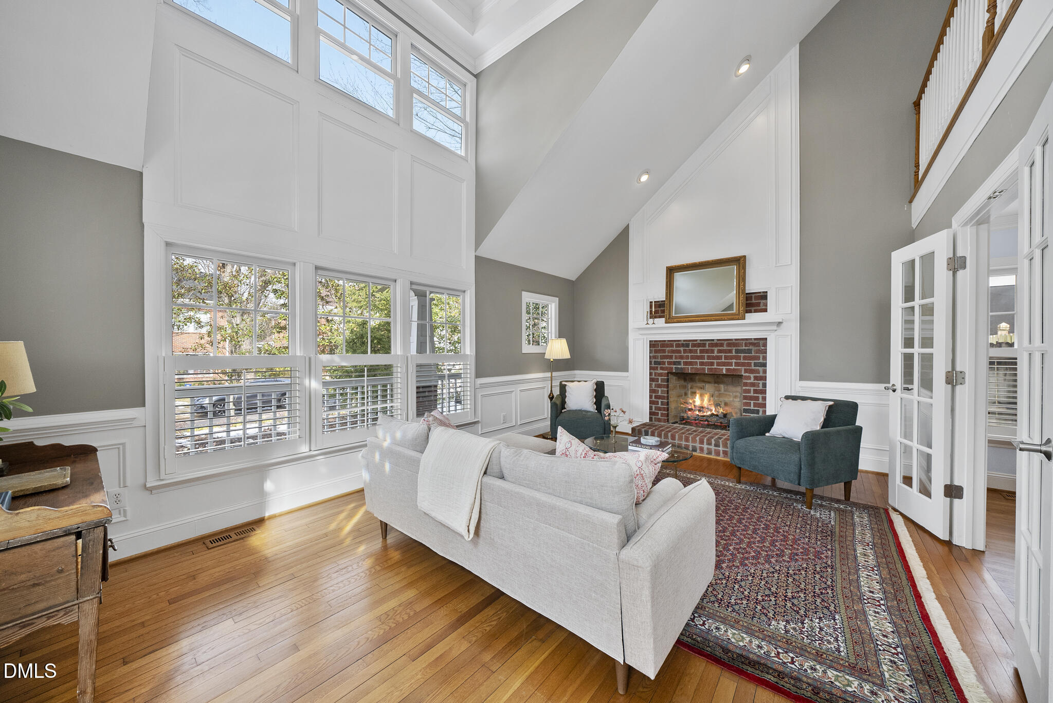 325 Morrison Avenue Raleigh, NC 27608 - Photo 5 of 42 a living room with furniture a large window and a fireplace