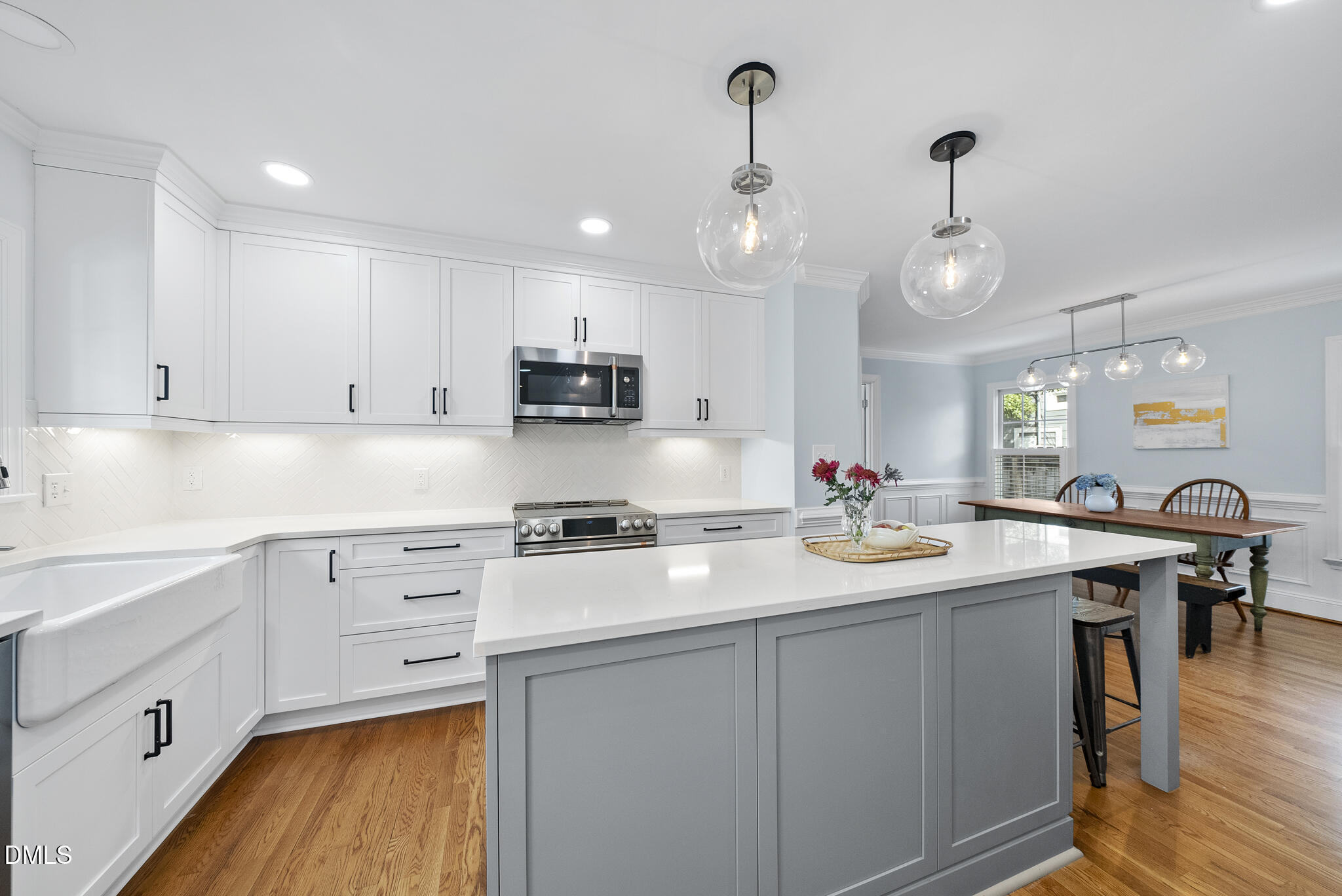 325 Morrison Avenue Raleigh, NC 27608 - Photo 7 of 42 a kitchen with kitchen island granite countertop a sink appliances cabinets and a center island