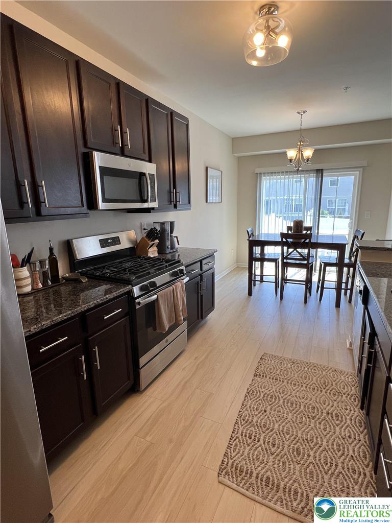 5380 Jutland Road Allentown, PA 18104 - Photo 6 of 27 Granite counters and stainless appliances define this modern, well-appointed culinary space, flowing into a bright dining area.