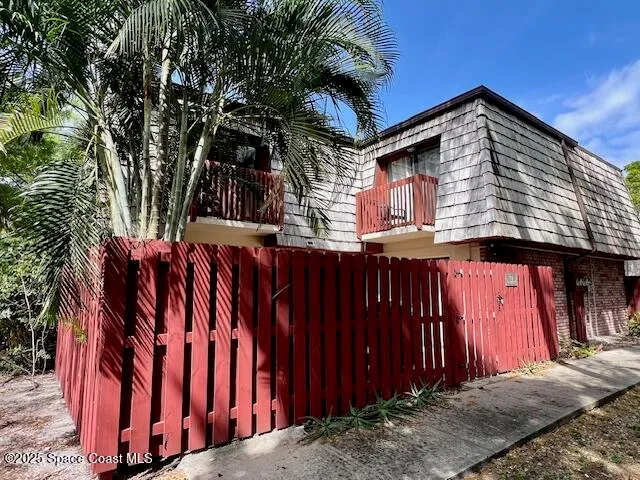a view of a house with wooden fence