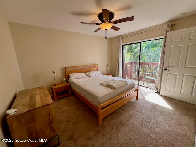 a bed sitting in a spacious bedroom next to a window