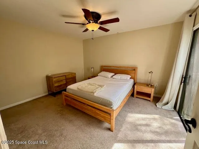 a bedroom with a bed and a ceiling fan