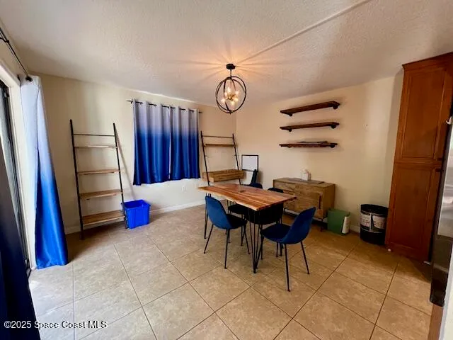 a view of a dining room with furniture and a chandelier