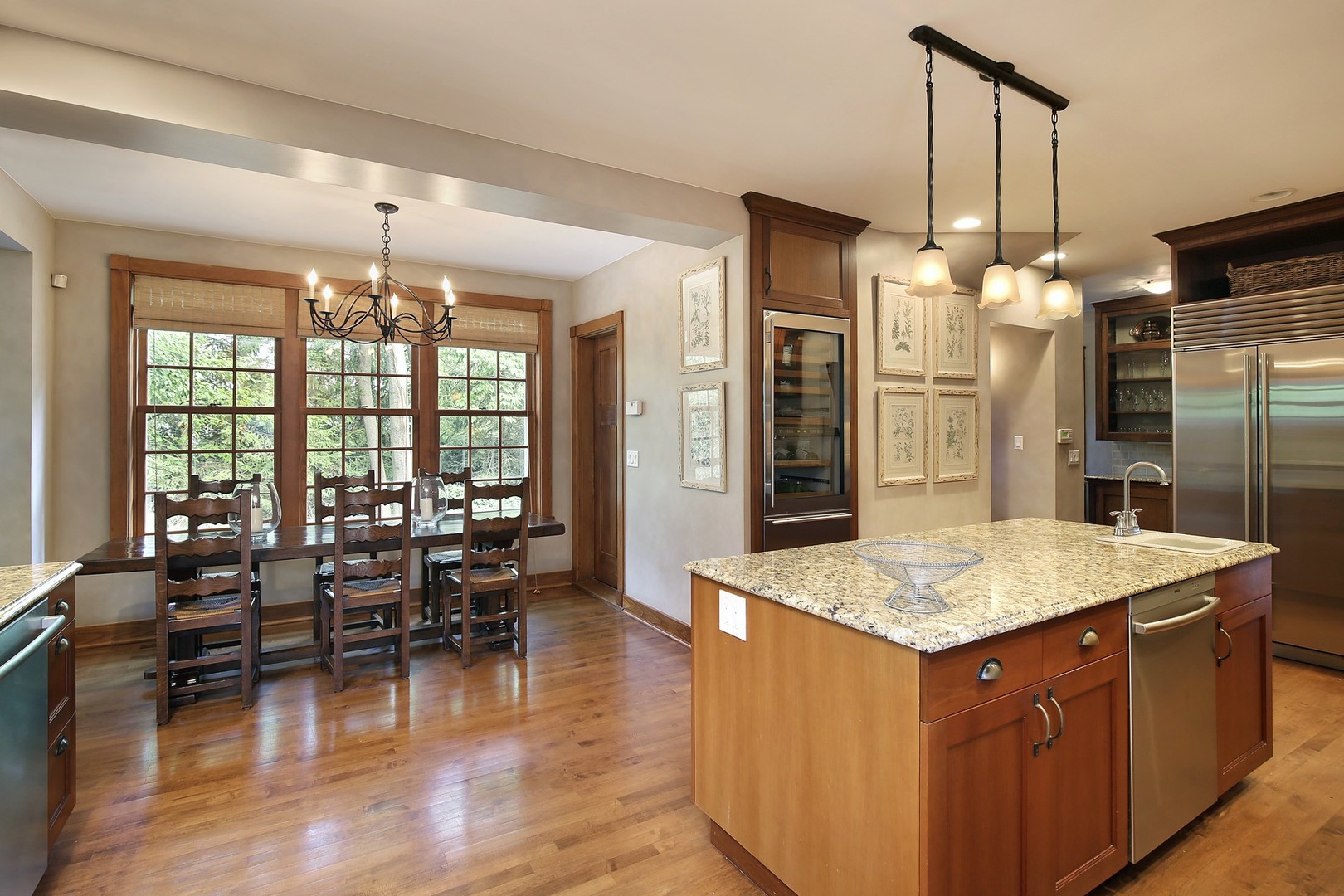 15 Old Green Bay Road Winnetka, IL 60093 - Photo 11 of 60 a large kitchen with kitchen island a large counter space dining table and a chandelier