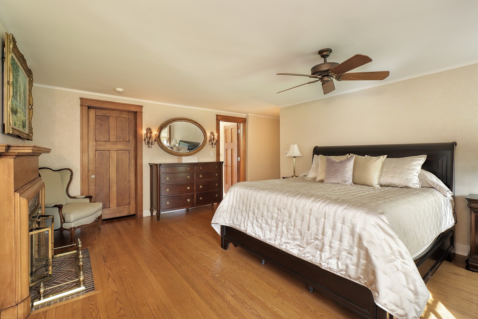 15 Old Green Bay Road Winnetka, IL 60093 - Photo 16 of 60 a bedroom with a bed a mirror on dresser and a chandelier
