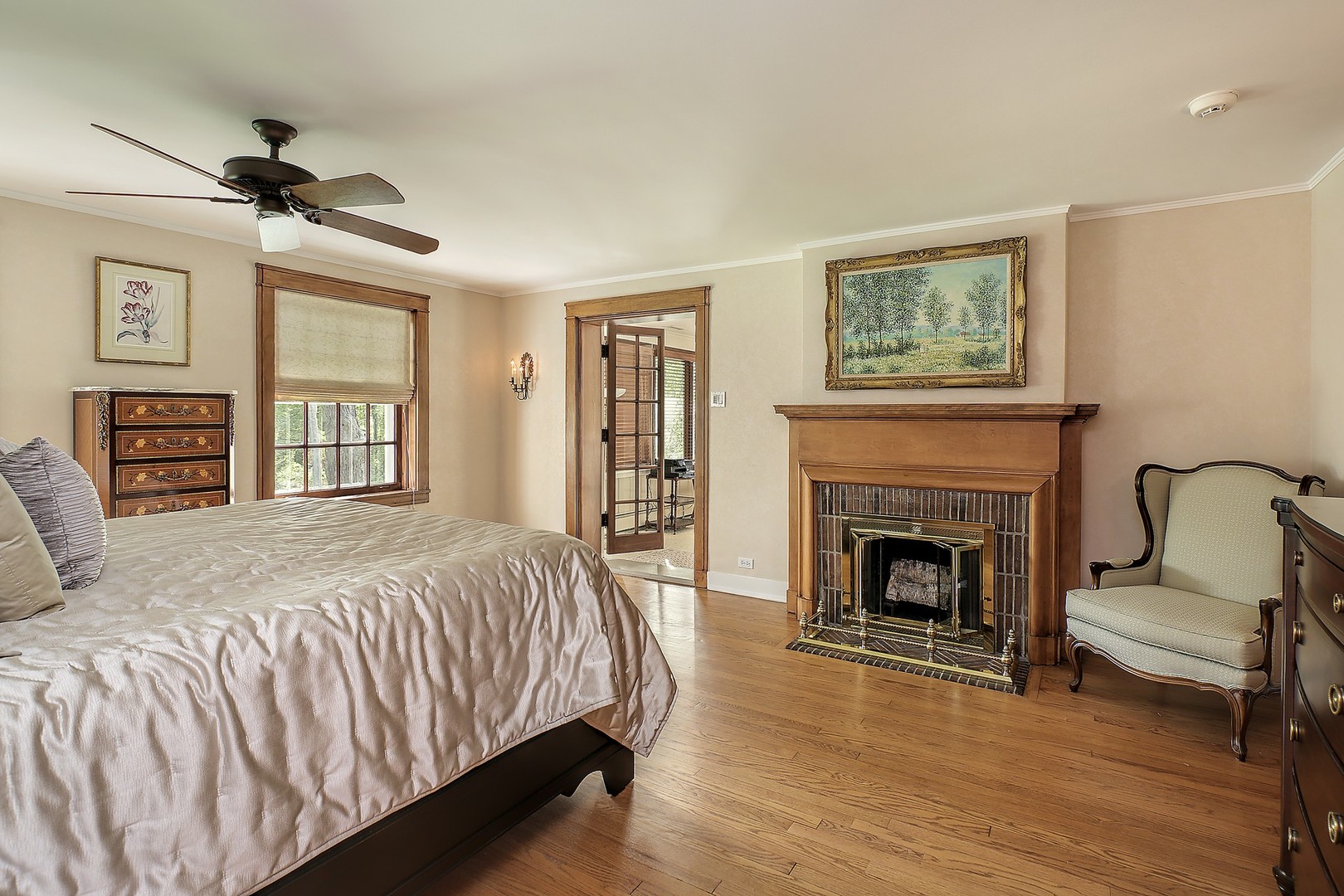 15 Old Green Bay Road Winnetka, IL 60093 - Photo 17 of 60 a spacious bedroom with a large bed a fireplace and two windows