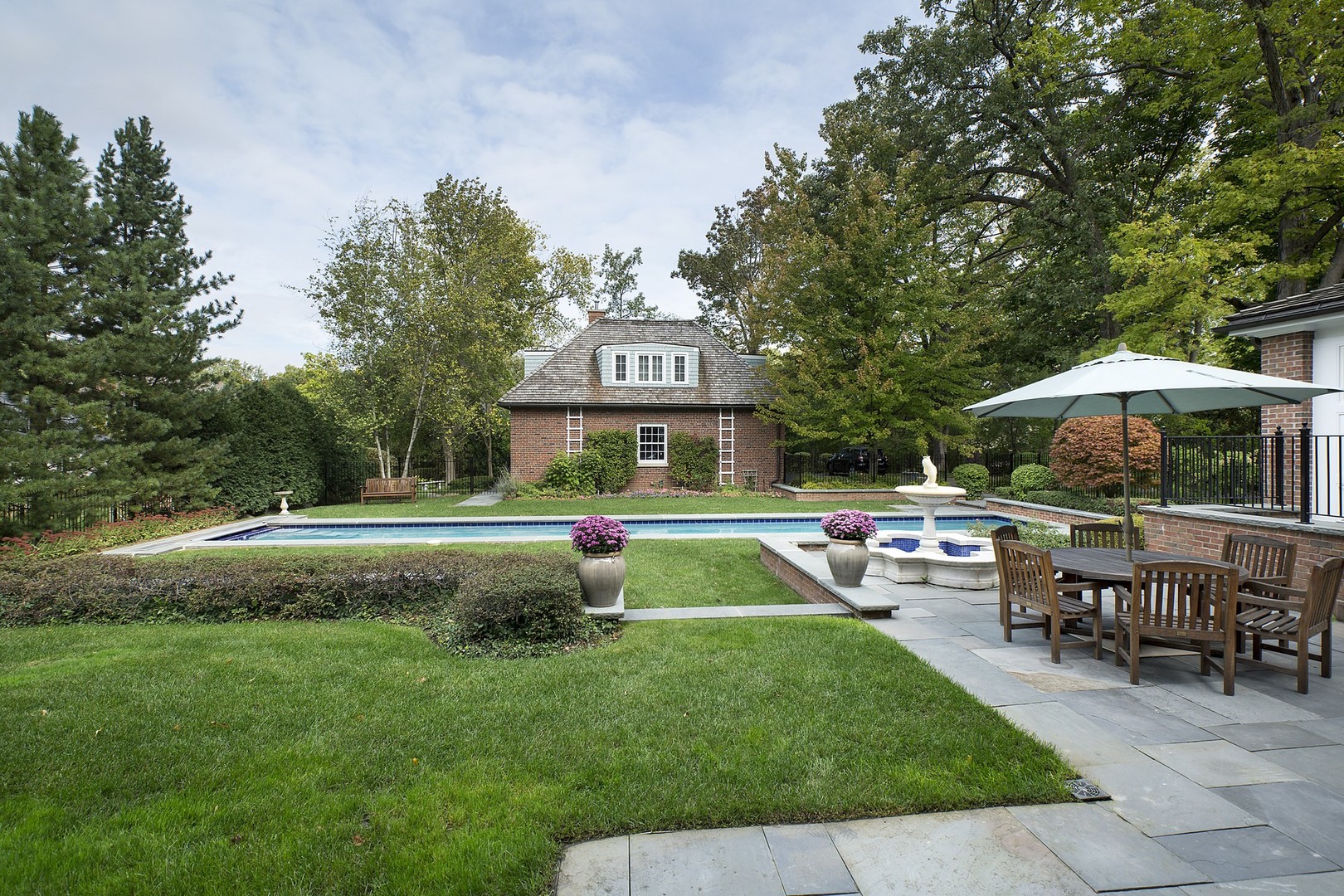 15 Old Green Bay Road Winnetka, IL 60093 - Photo 36 of 60 a view of patio with table and chairs under an umbrella