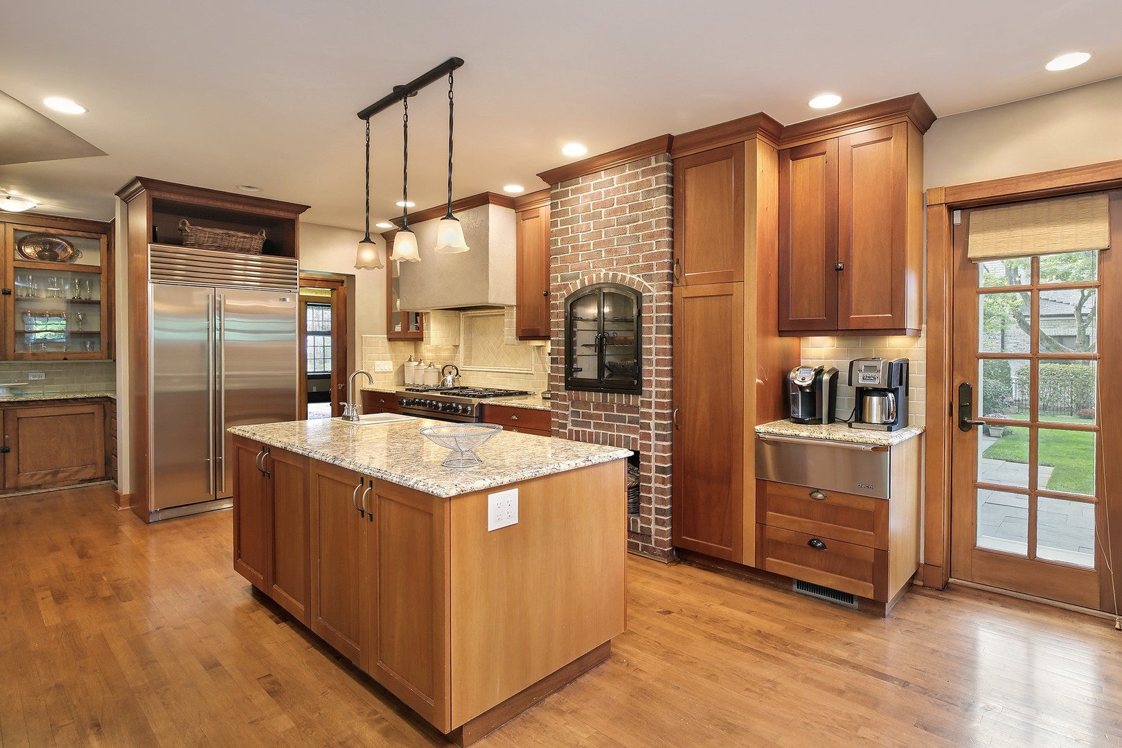 15 Old Green Bay Road Winnetka, IL 60093 - Photo 10 of 60 a kitchen with stainless steel appliances granite countertop a stove and a refrigerator