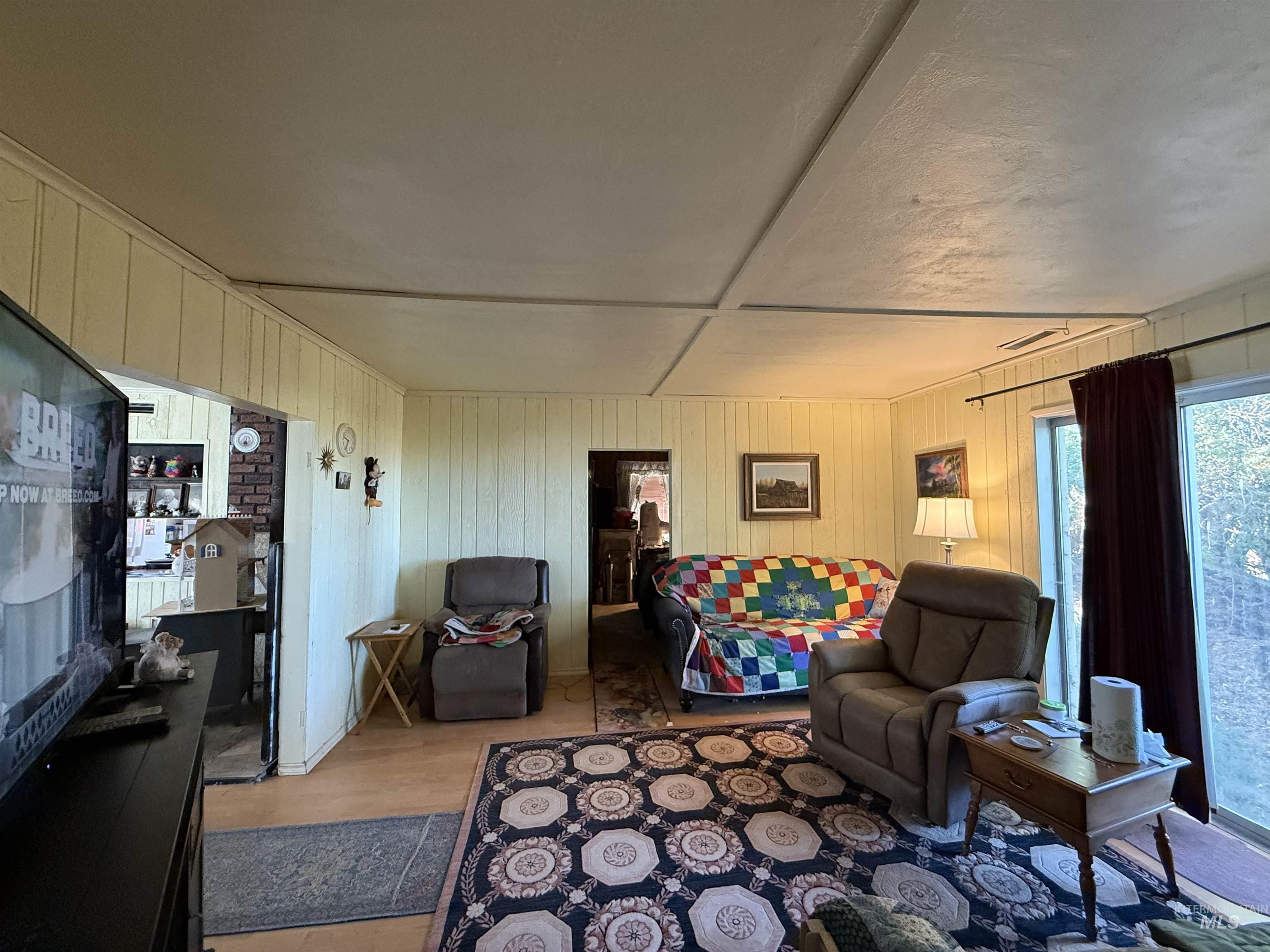 19241 West Homedale Road Caldwell, ID 83607 - Photo 24 of 35 Living room featuring wooden walls and light wood finished floors